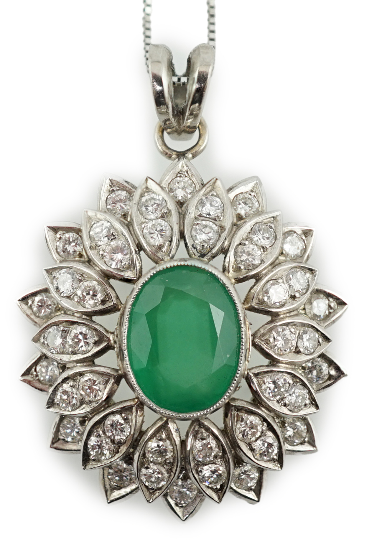 A modern platinum, emerald and diamond cluster set oval pendant